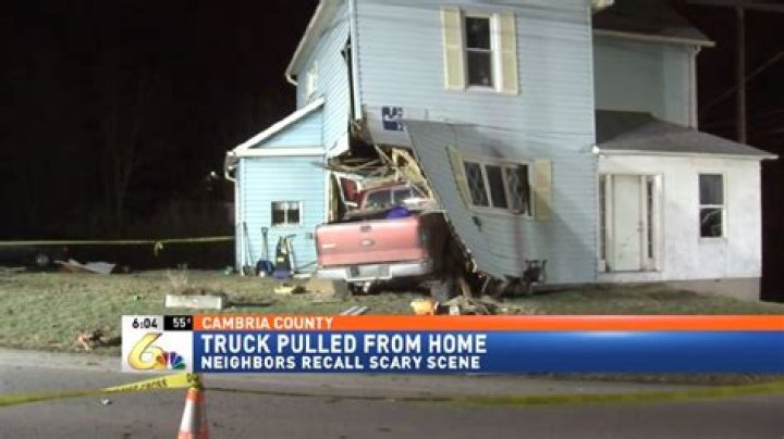 Truck crashes into home while woman is inside